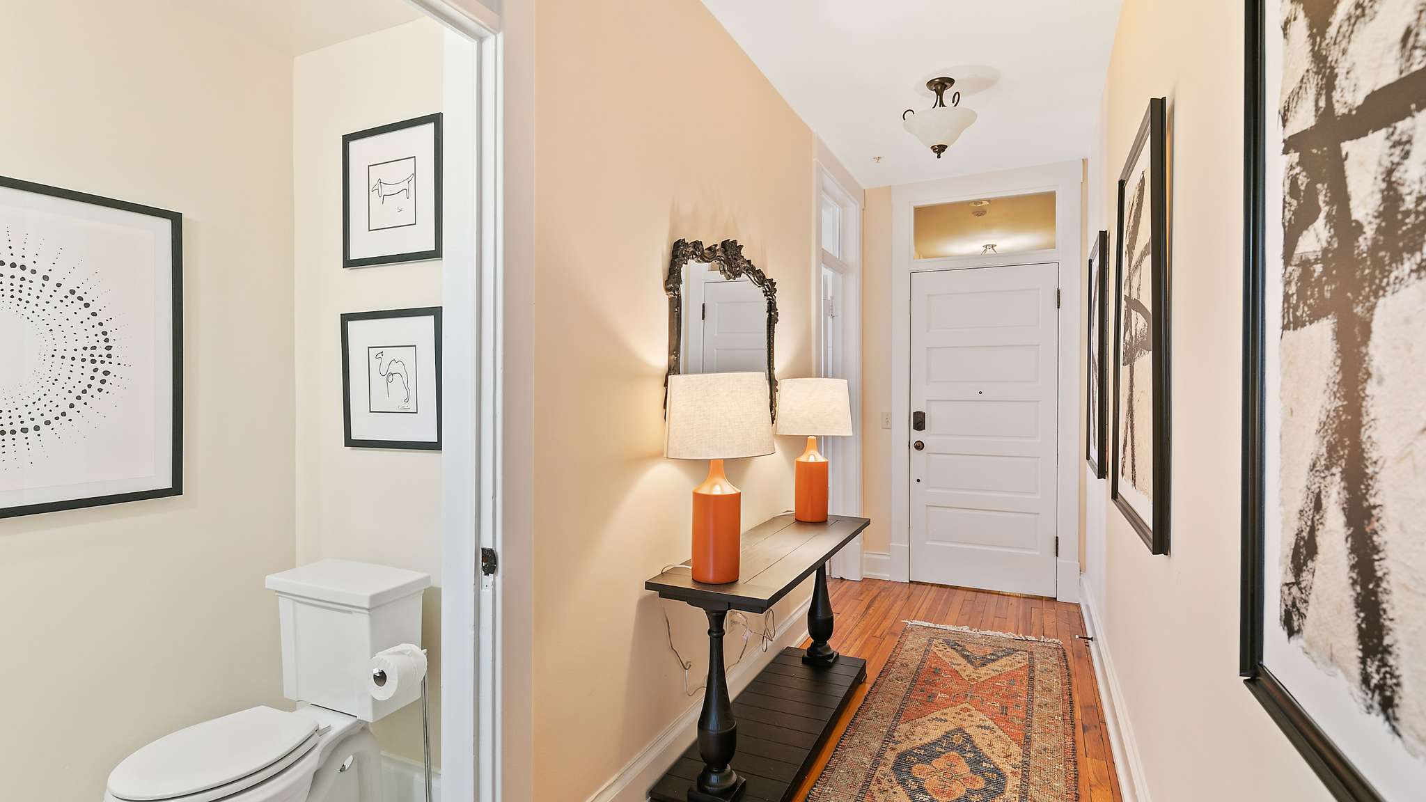 Hallway with mirror and lamps.