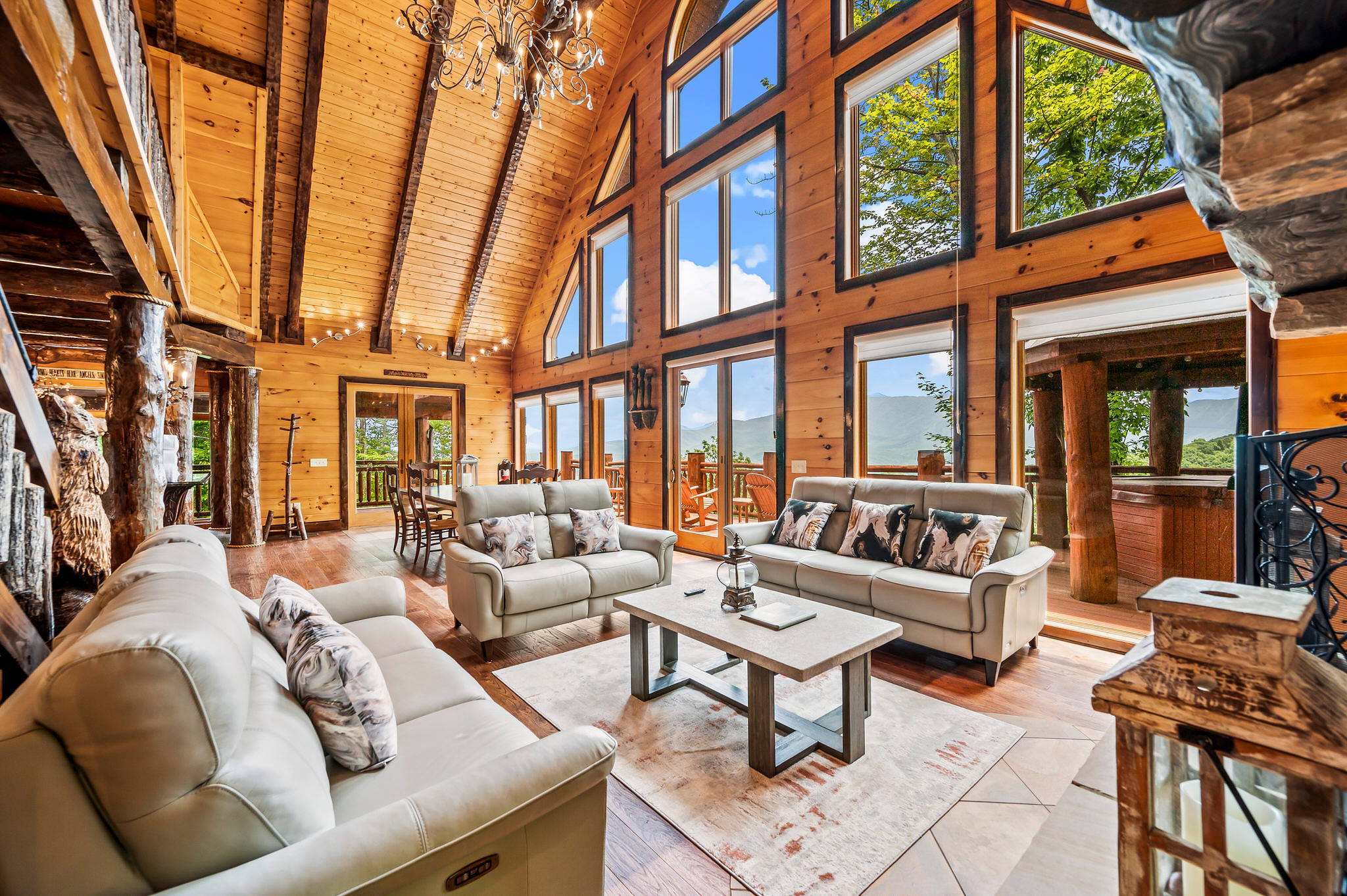 Rustic cabin interior with large windows.