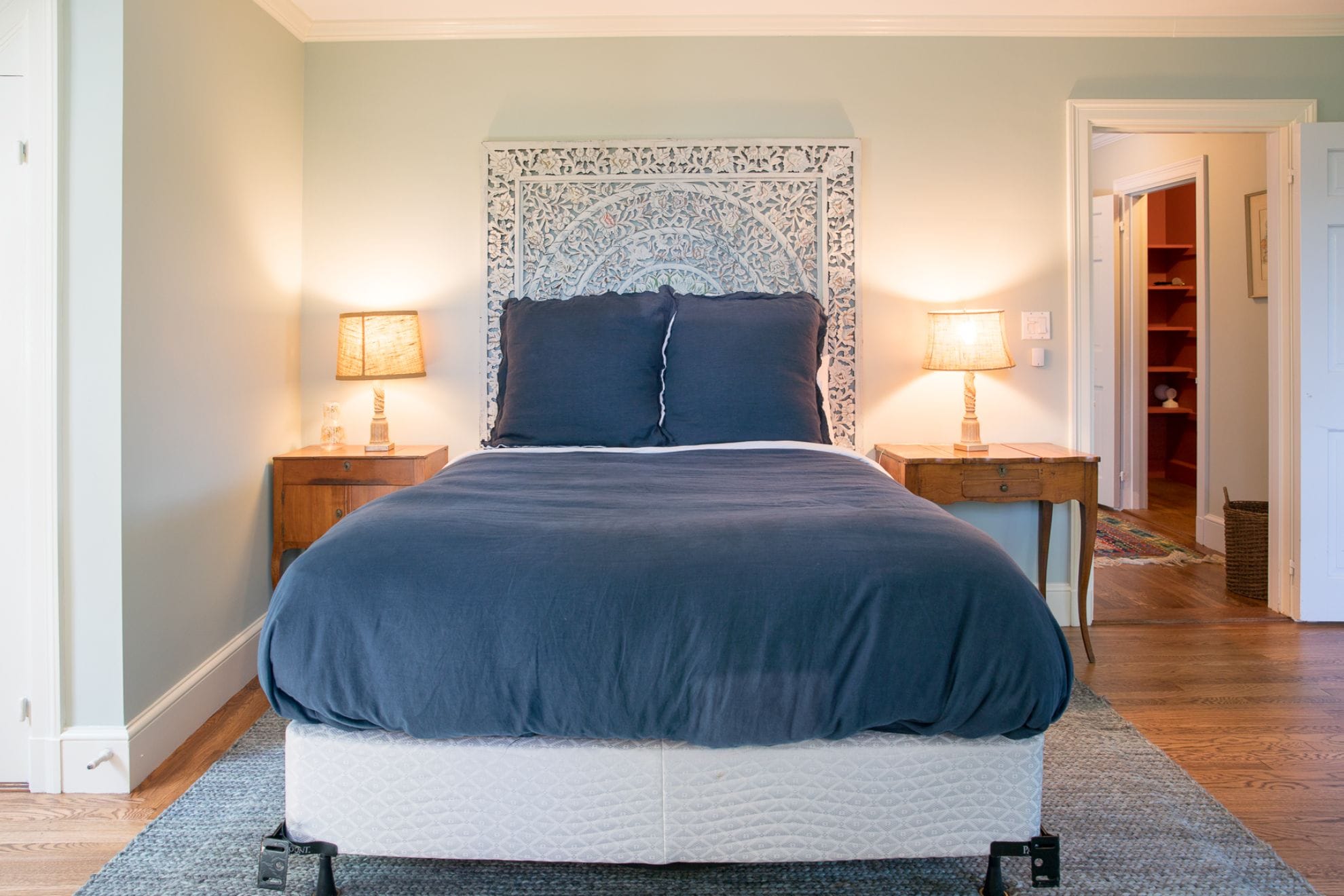 Cozy bedroom with lit lamps.