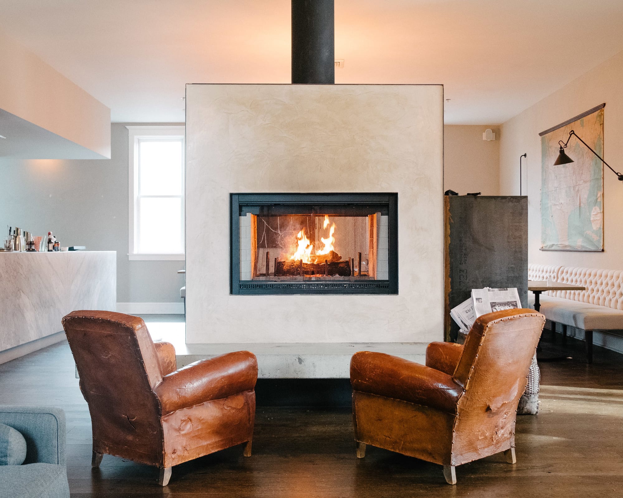 Two chairs near cozy fireplace.