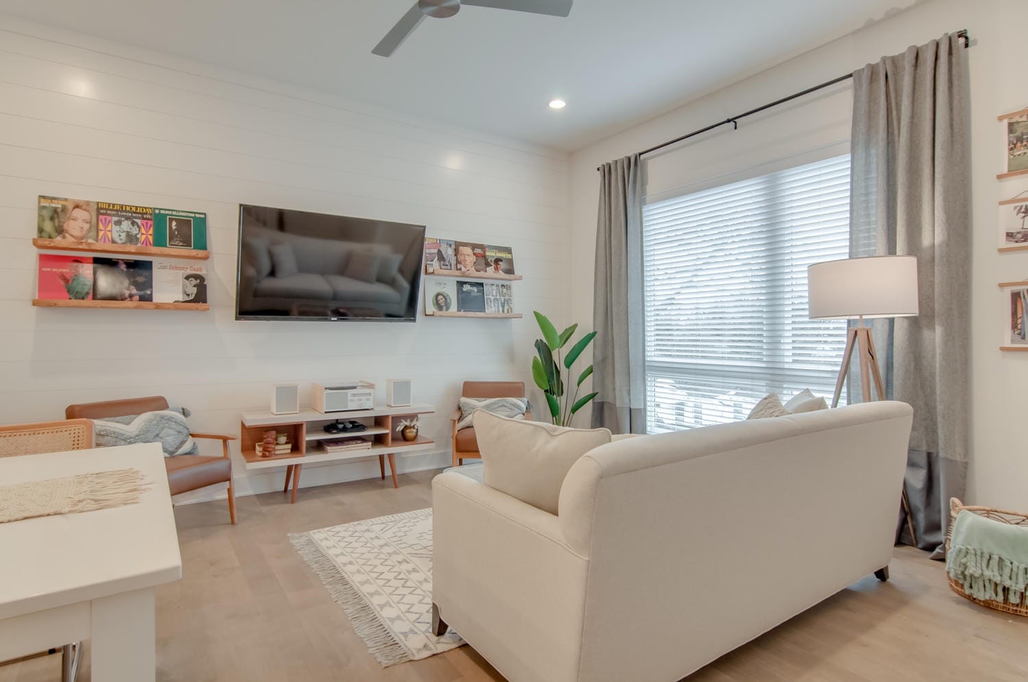 Modern living room with wall-mounted TV.