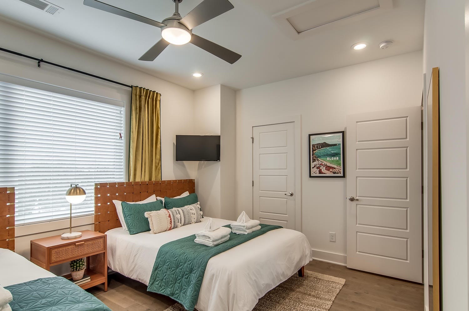 Bedroom with double bed and TV.