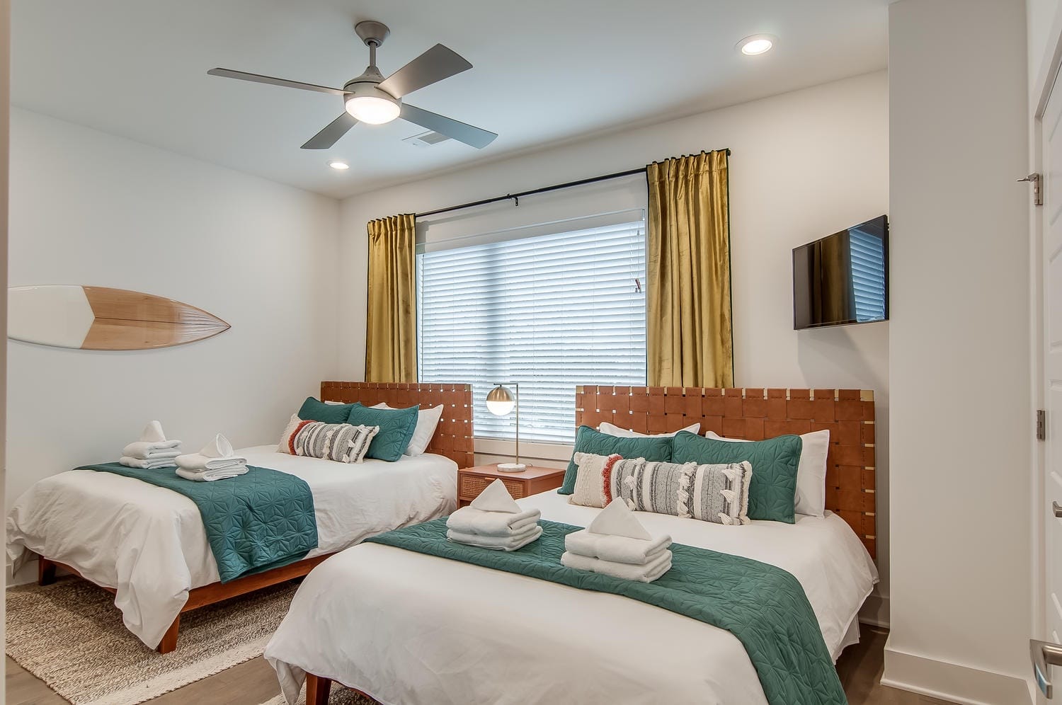 Bedroom with two beds and TV.