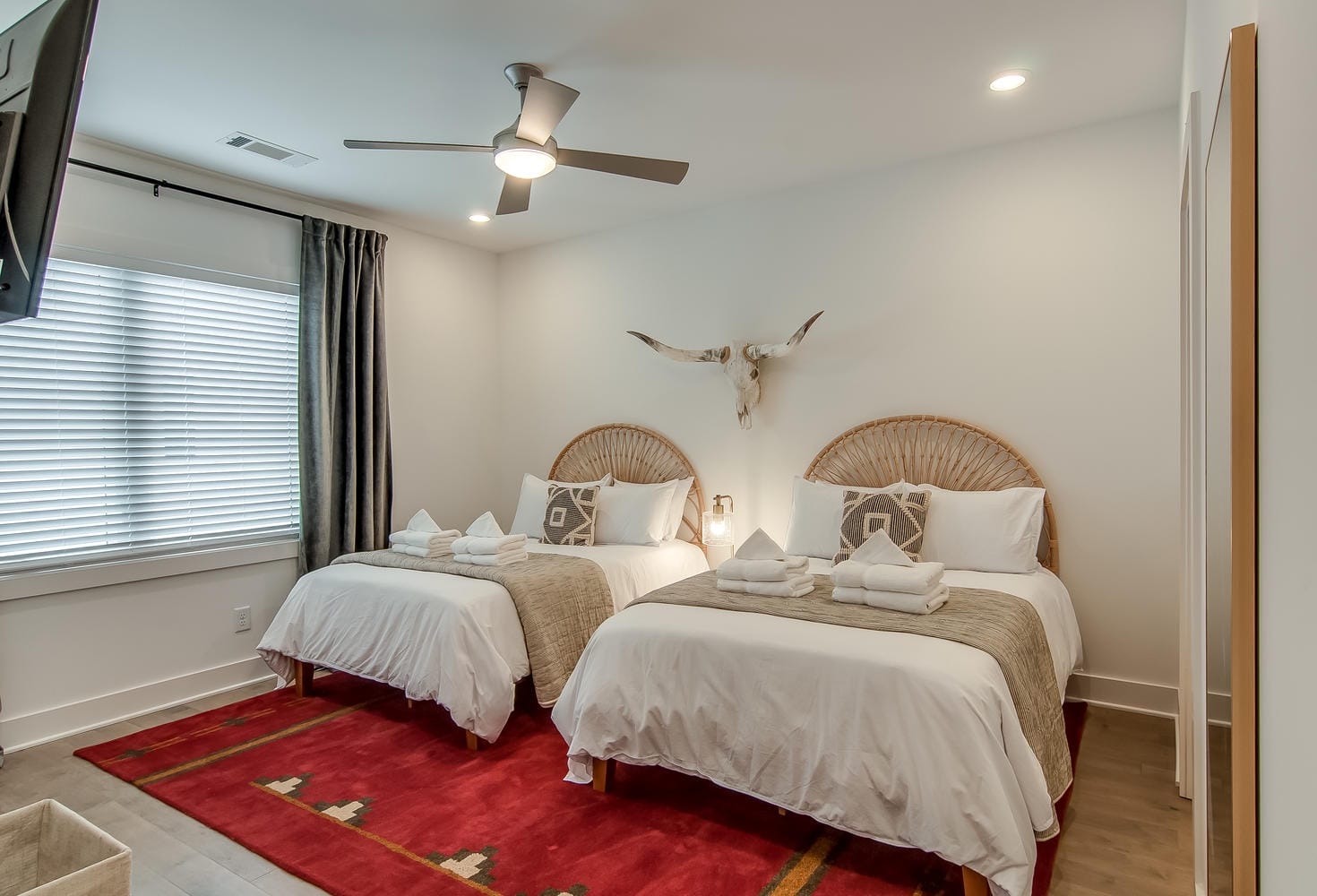 Two beds in stylish bedroom.