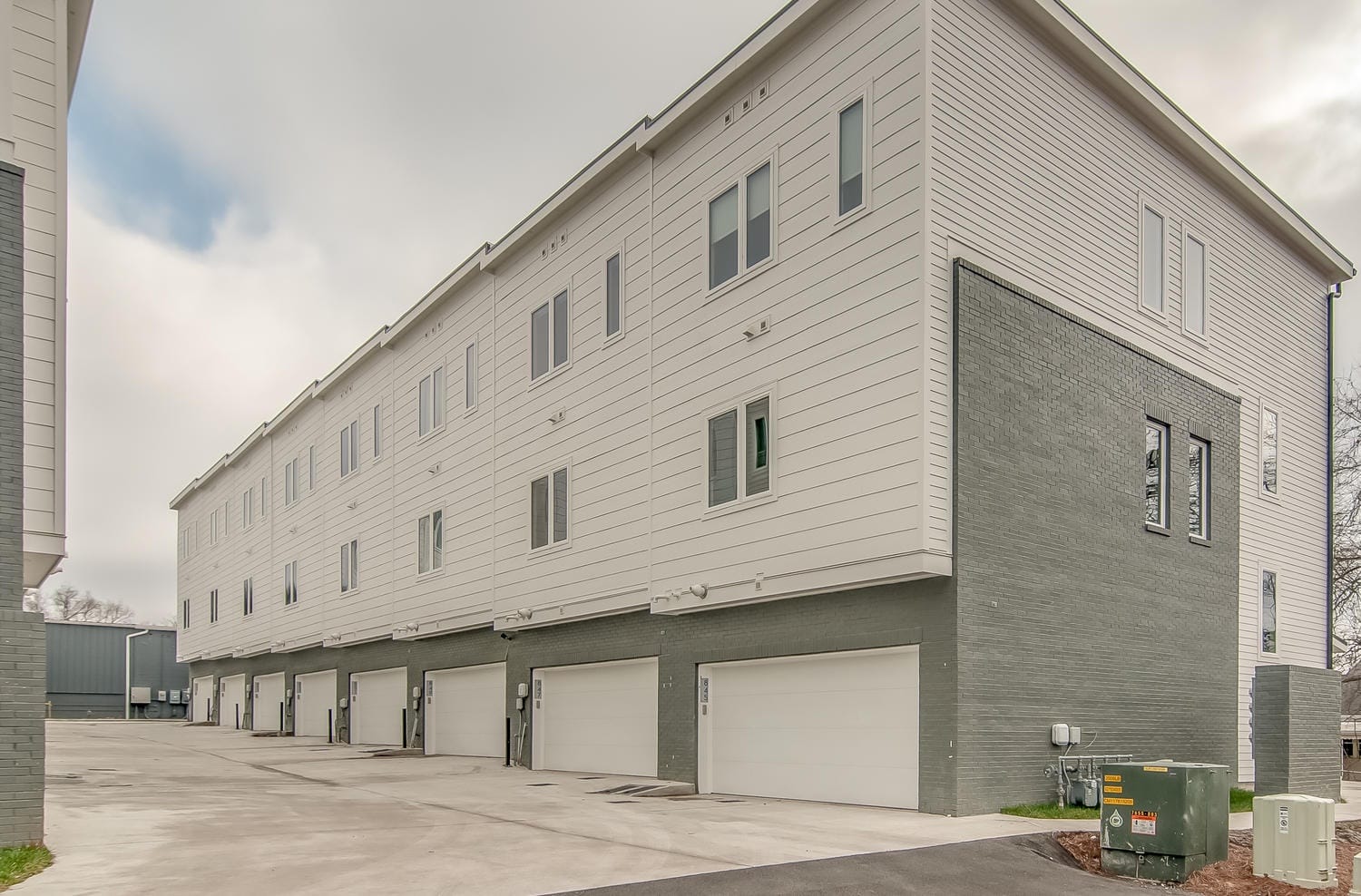 Modern townhouses with garages shown.