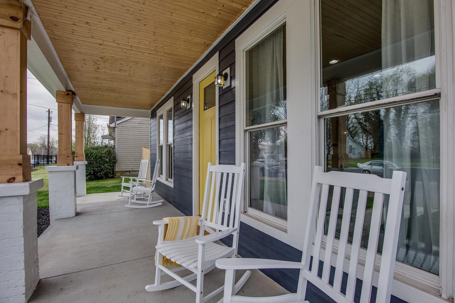 Porch with white rocking chairs.