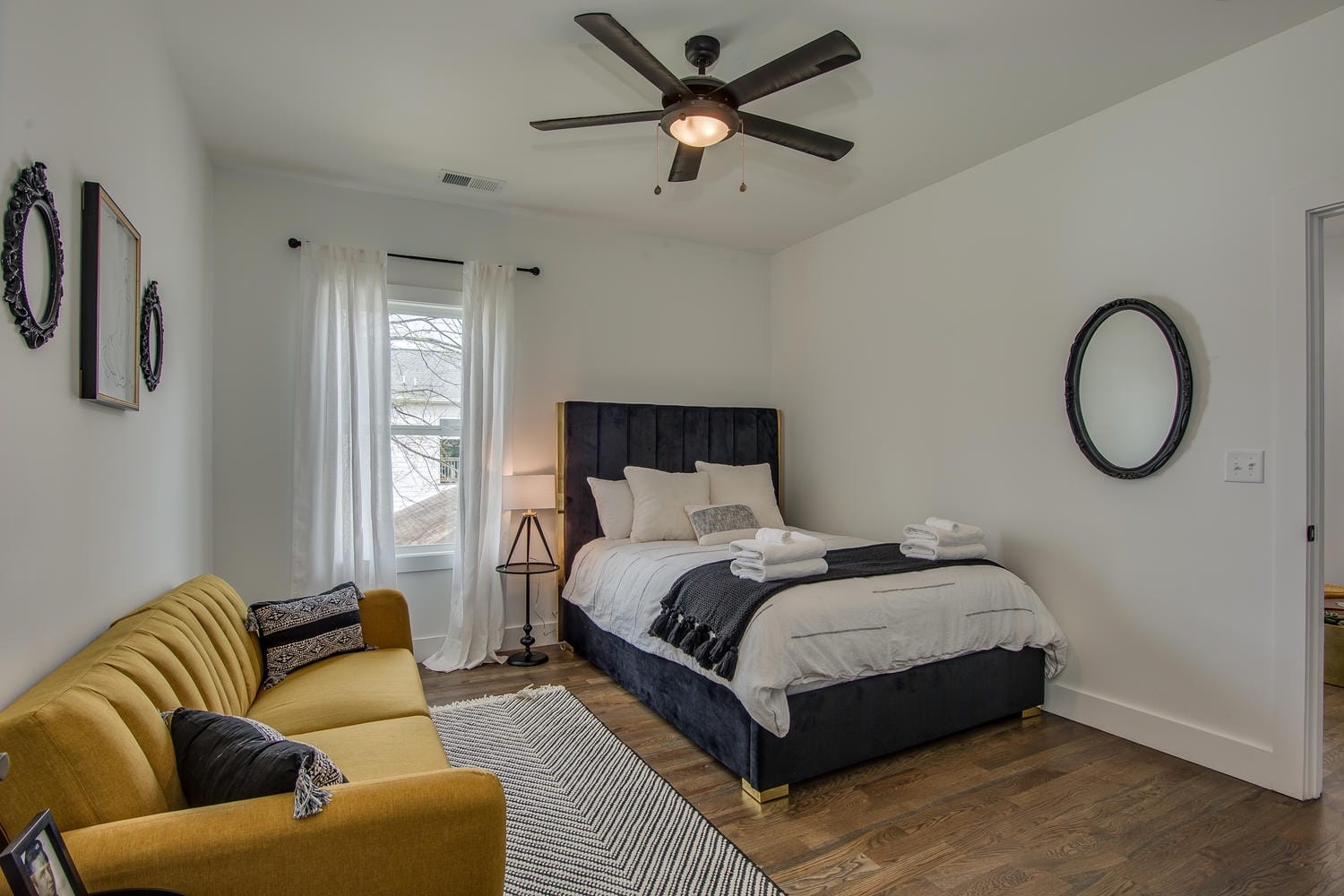 Cozy bedroom with yellow couch.