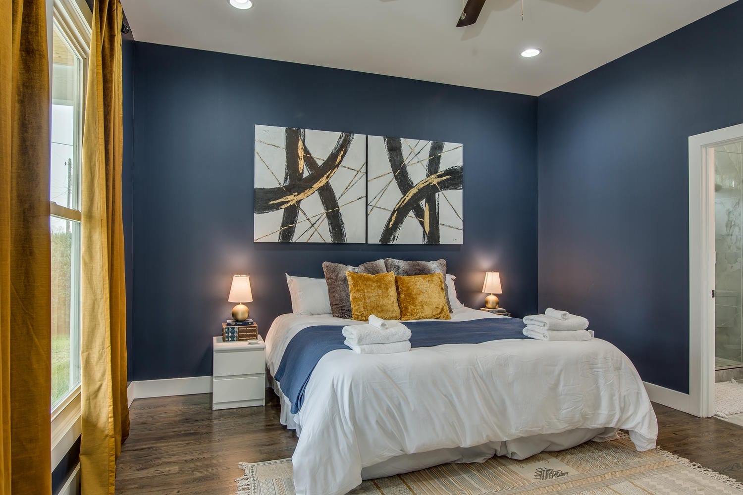 Modern bedroom with dark blue walls.