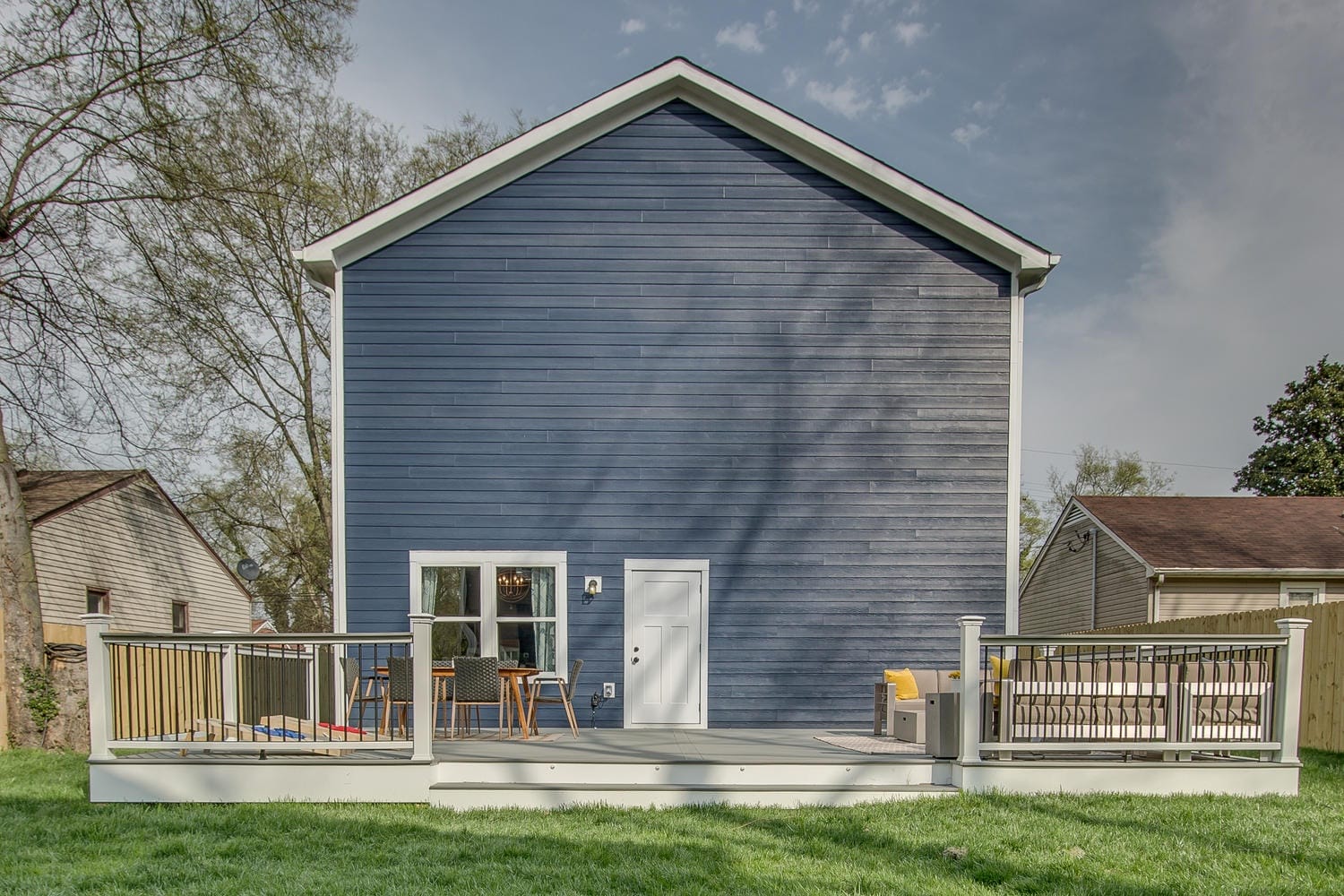 Blue house with backyard deck