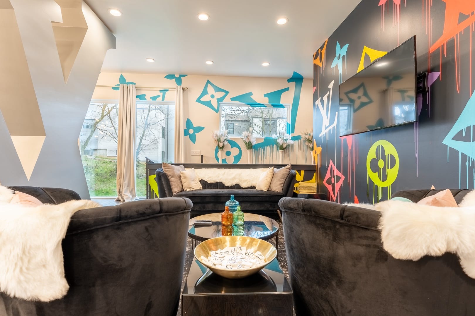 Modern living room with colorful graffiti.