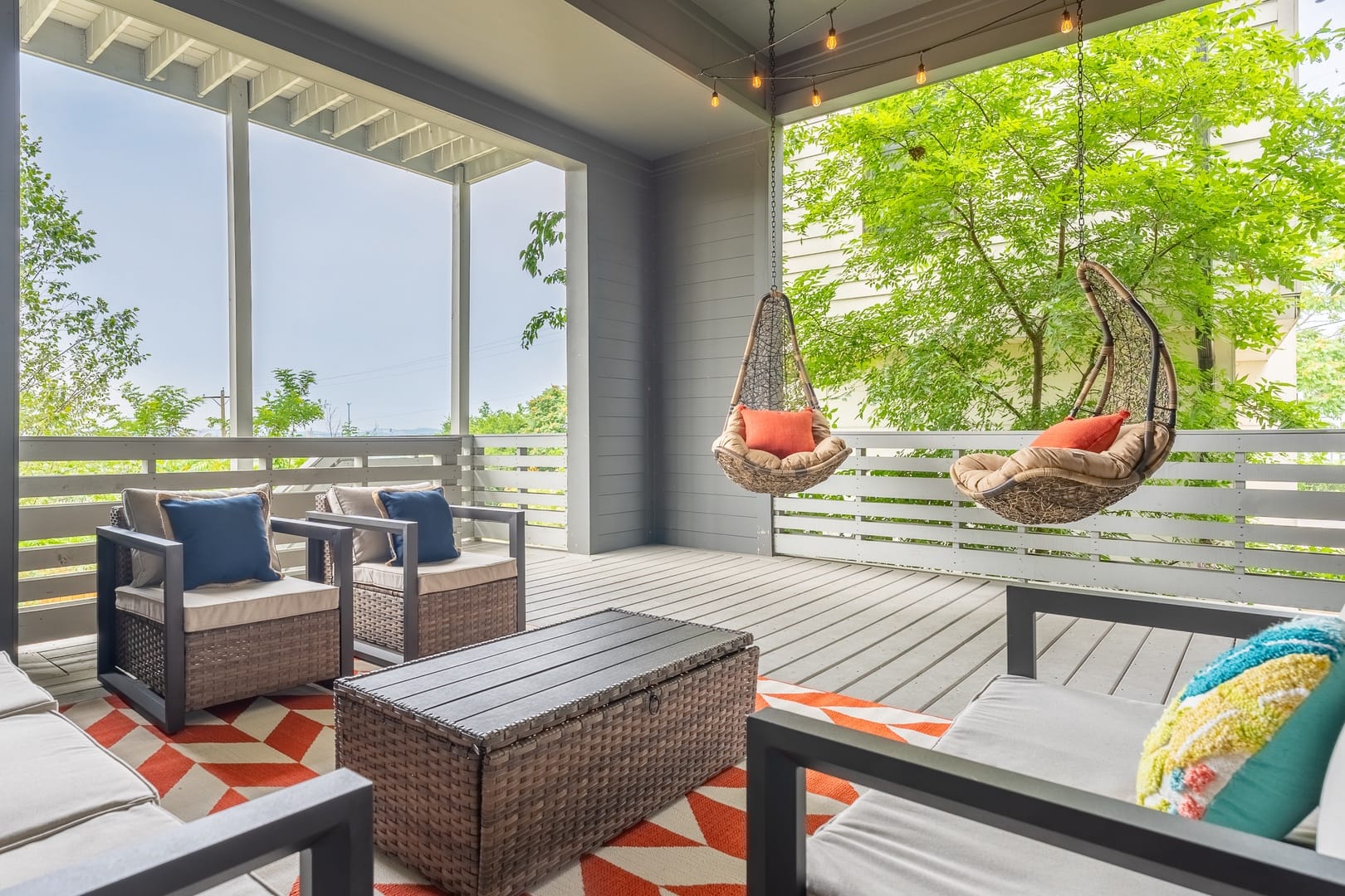 Cozy patio with hanging chairs.