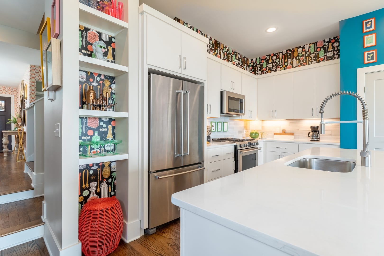 Modern kitchen with colorful wallpaper.