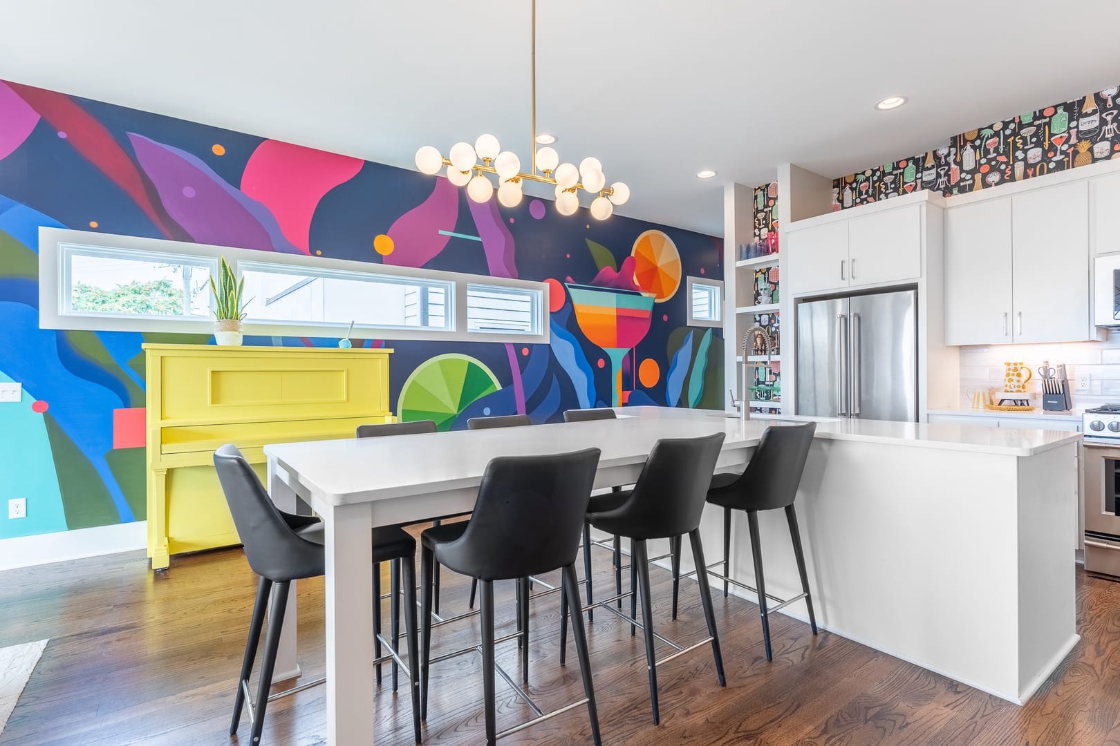 Colorful kitchen with mural wall.