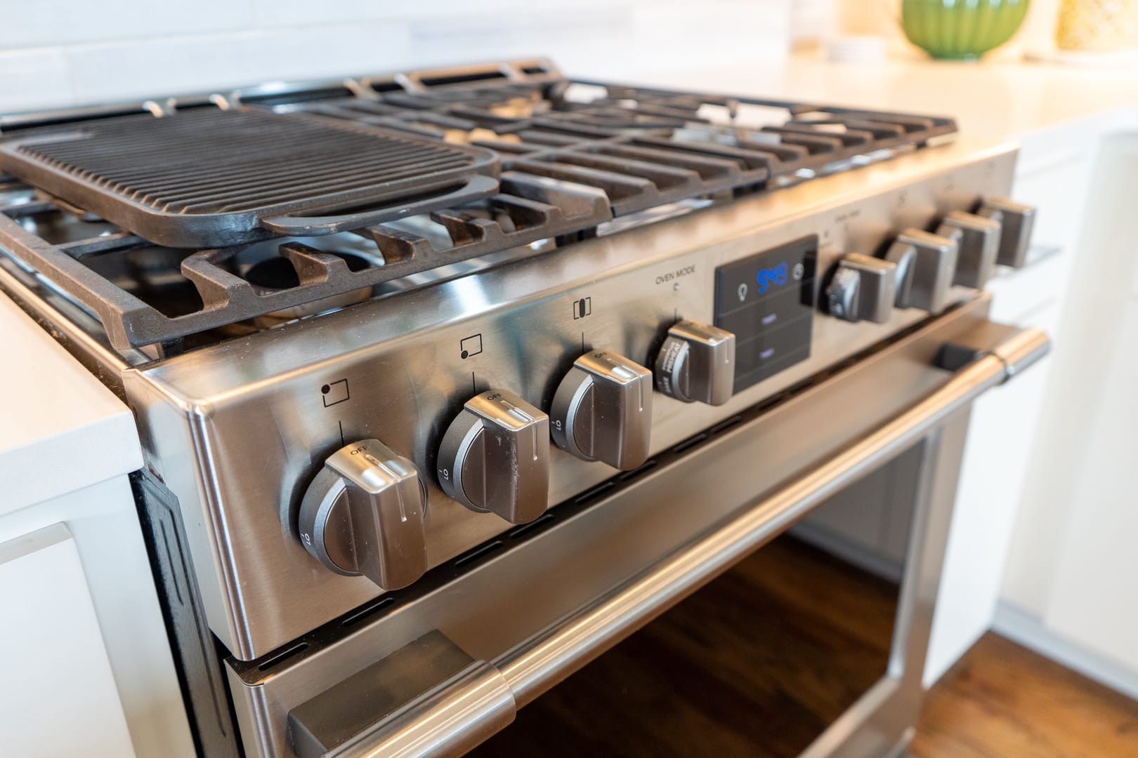 Stainless steel gas stove with griddle.