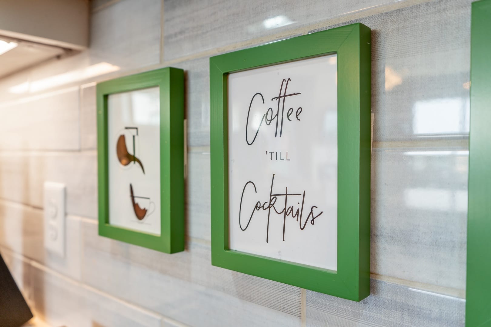 Green-framed signs on tiled wall.