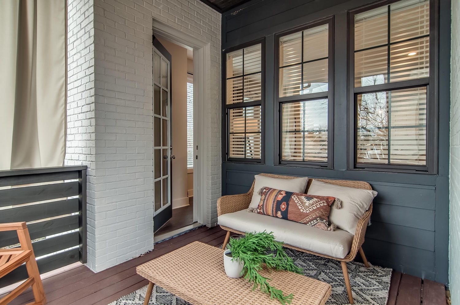 Cozy porch with wicker seating.