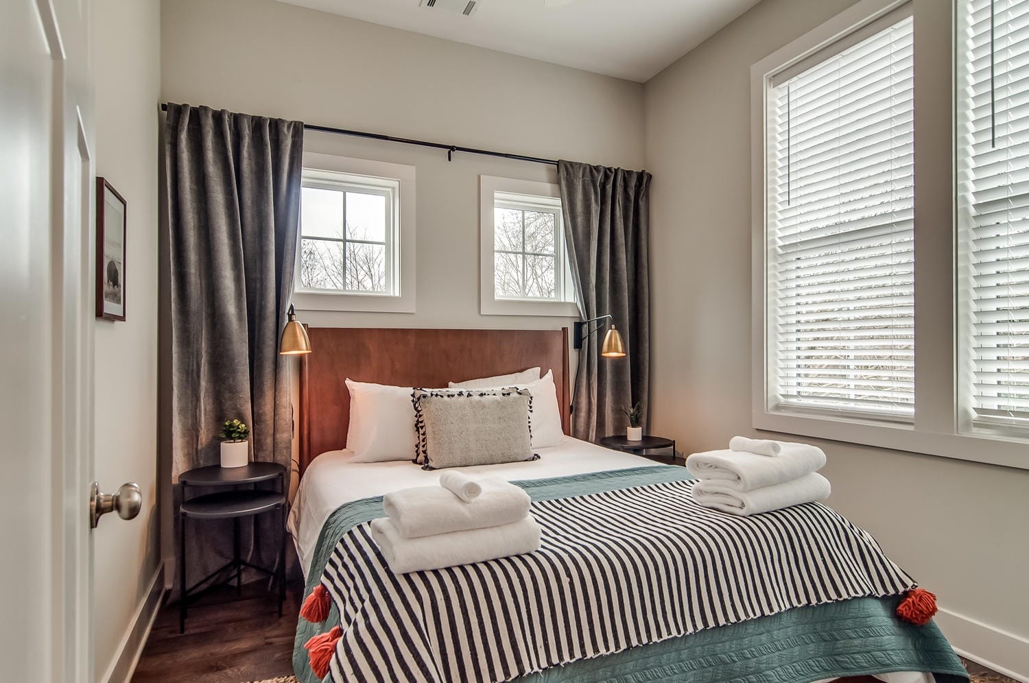 Cozy bedroom with striped blanket.