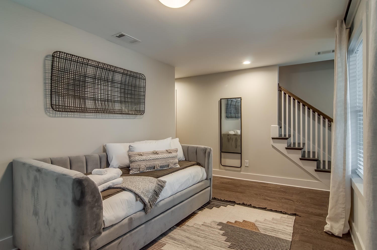 Cozy room with daybed and stairs.