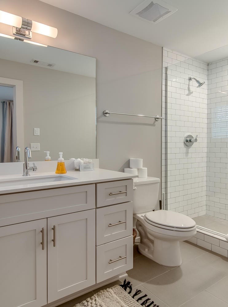 Modern bathroom with shower and vanity.