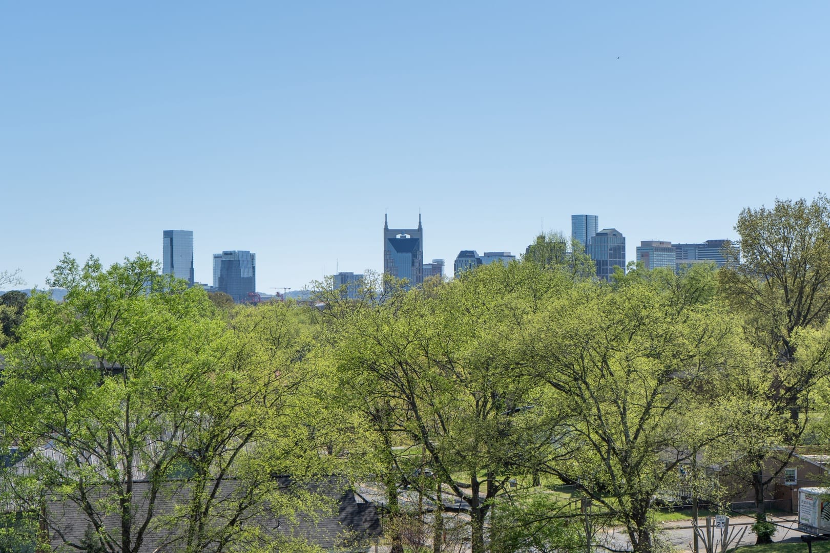 City skyline with trees in foreground.