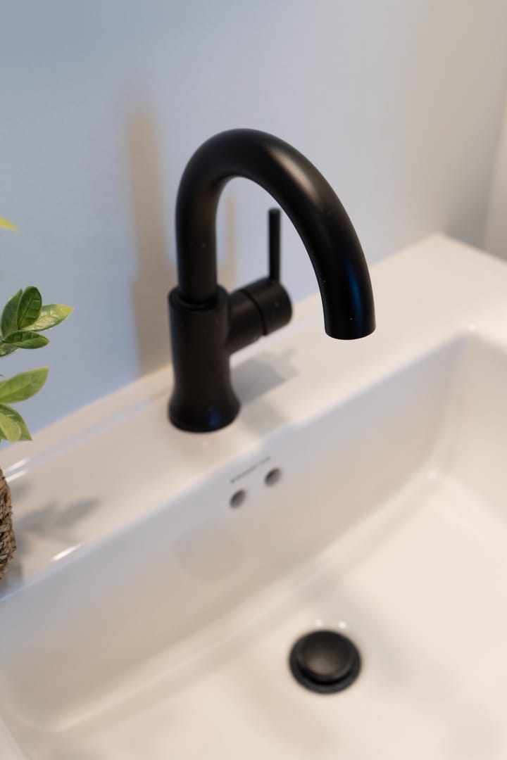 Black faucet on white sink.