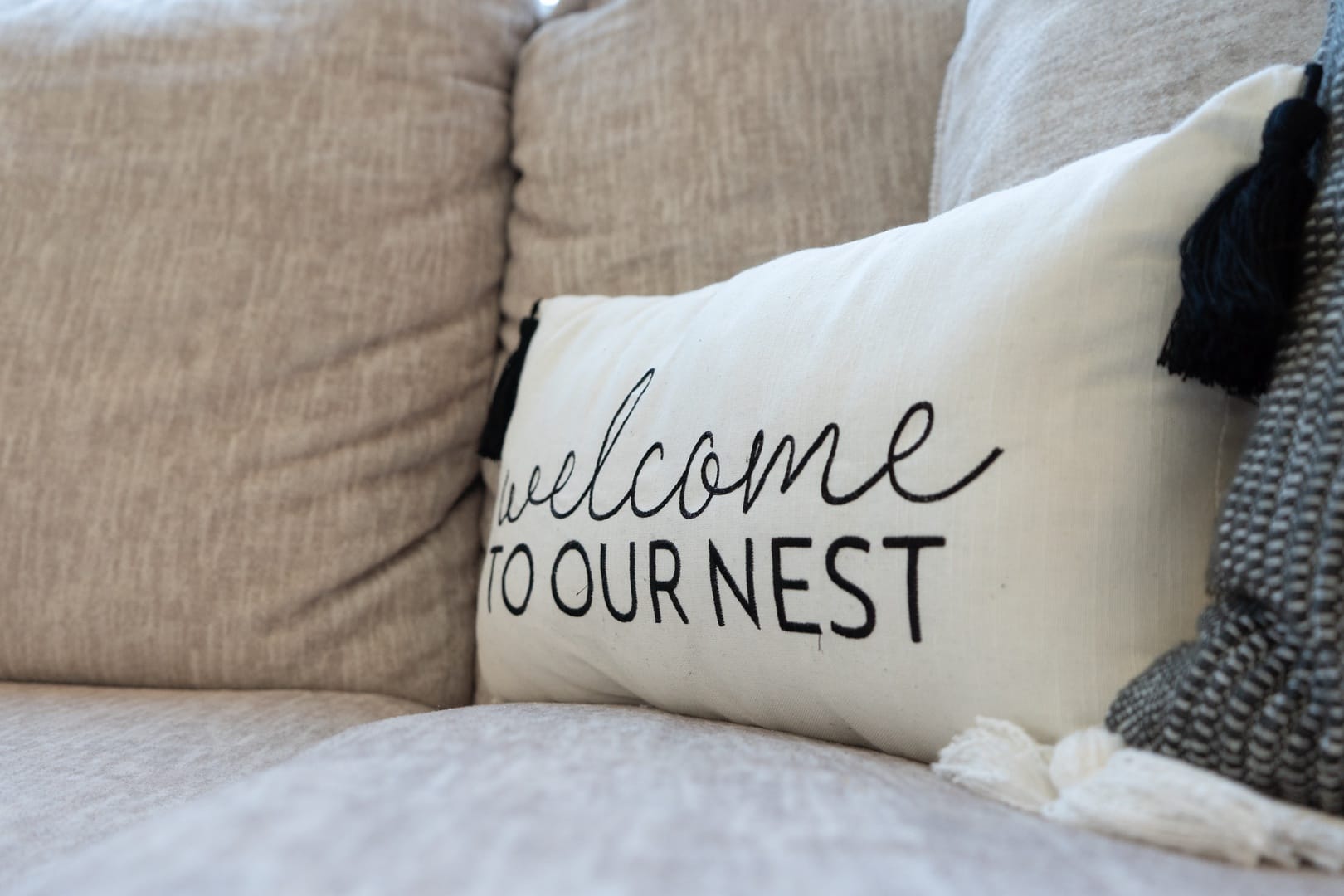 Pillow with "welcome to nest."