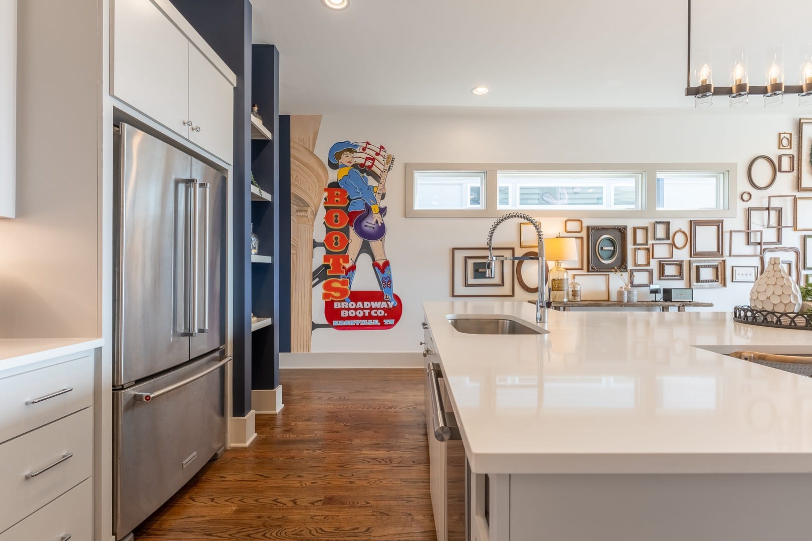 Modern kitchen with colorful wall art.