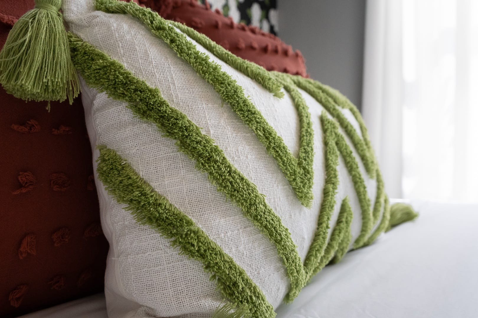 White cushion with green stripes.