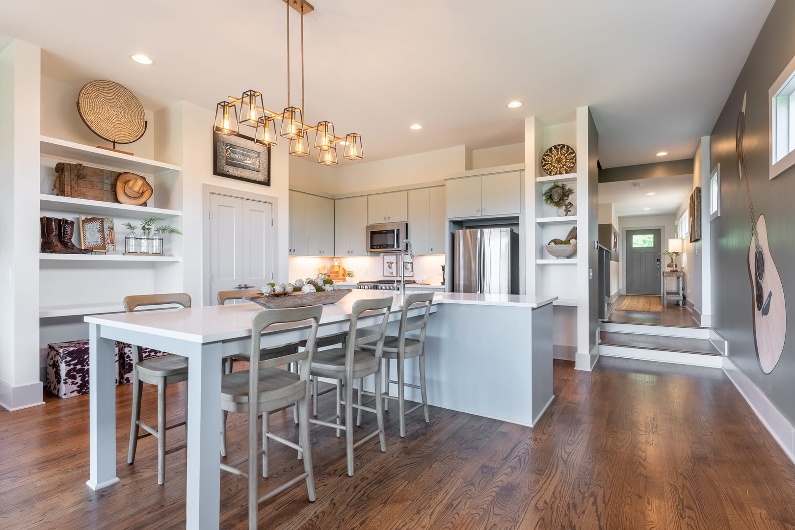 Modern kitchen with island and stools.