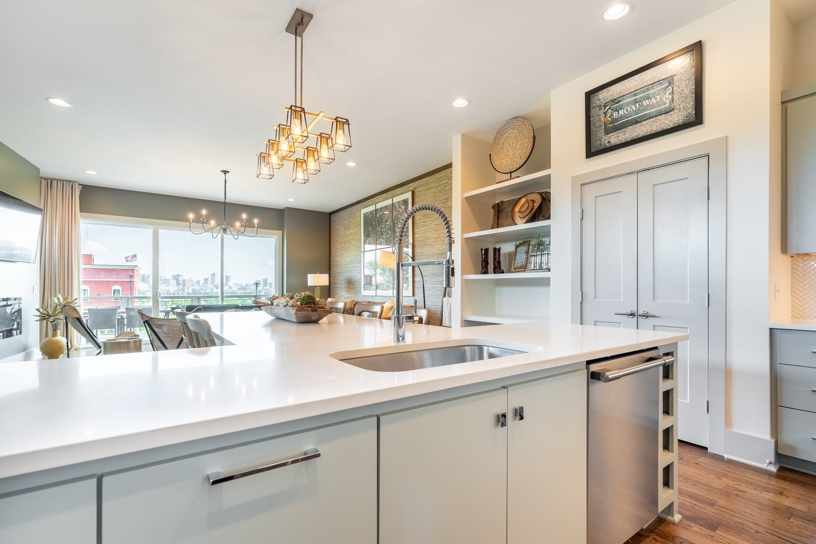 Modern kitchen with island and chandeliers.