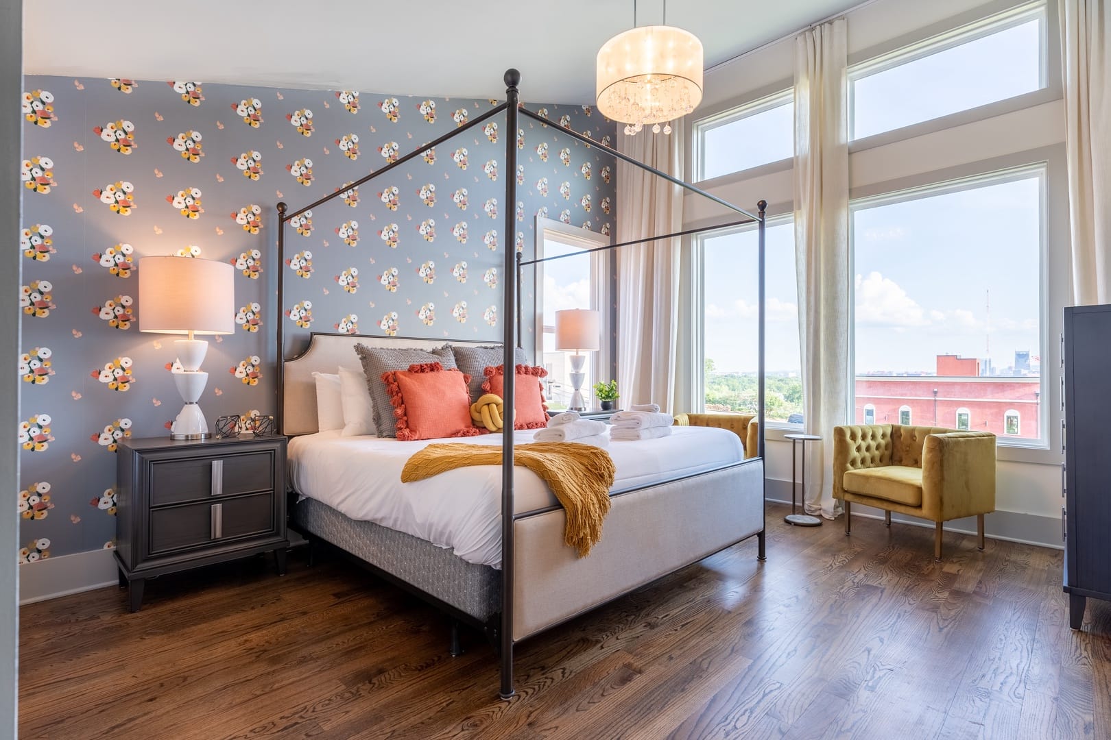 Spacious bedroom with patterned wallpaper.