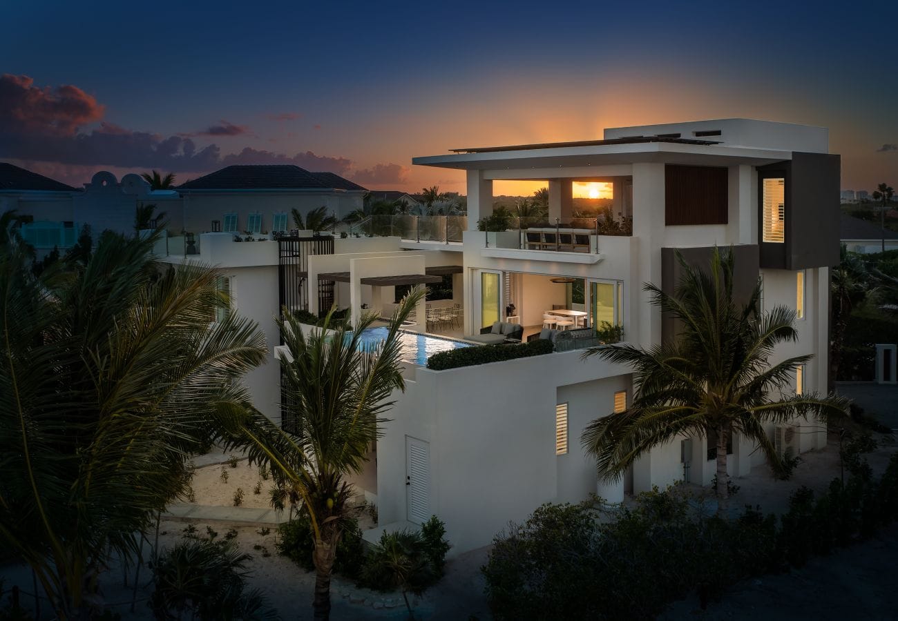 Modern villa at sunset with pool.