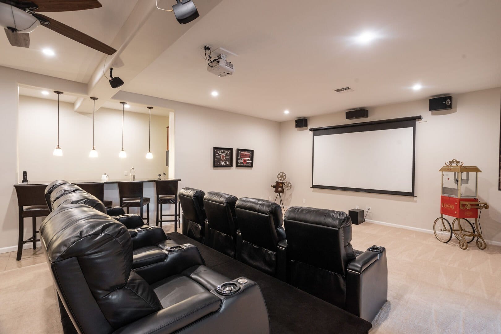 Home theater with recliners and screen.