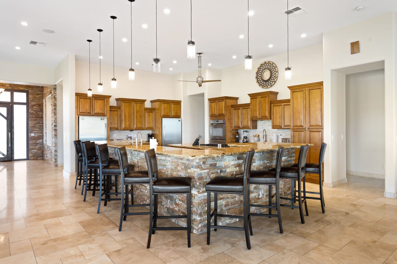 Modern kitchen with island and stools.