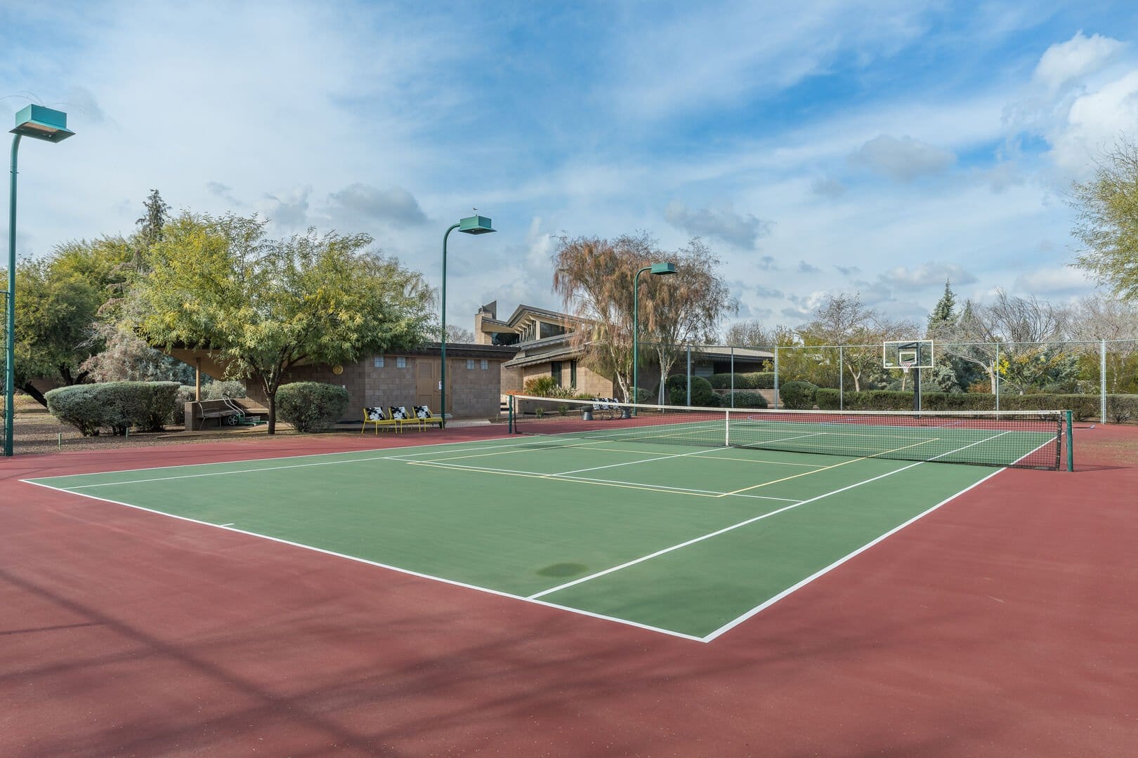 Empty outdoor tennis court daytime.