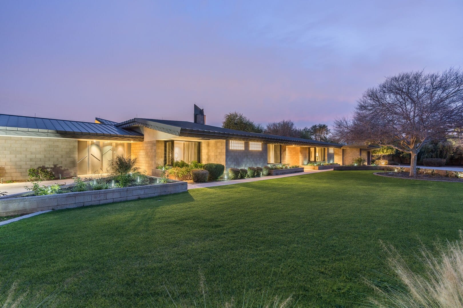 Single-story modern house and yard.