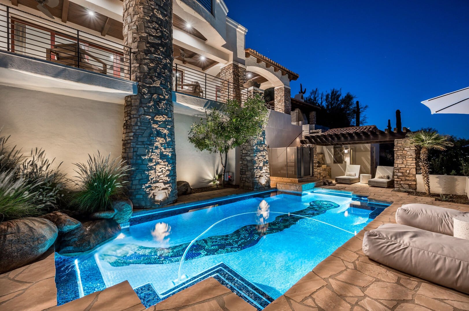 Luxurious poolside villa at night.