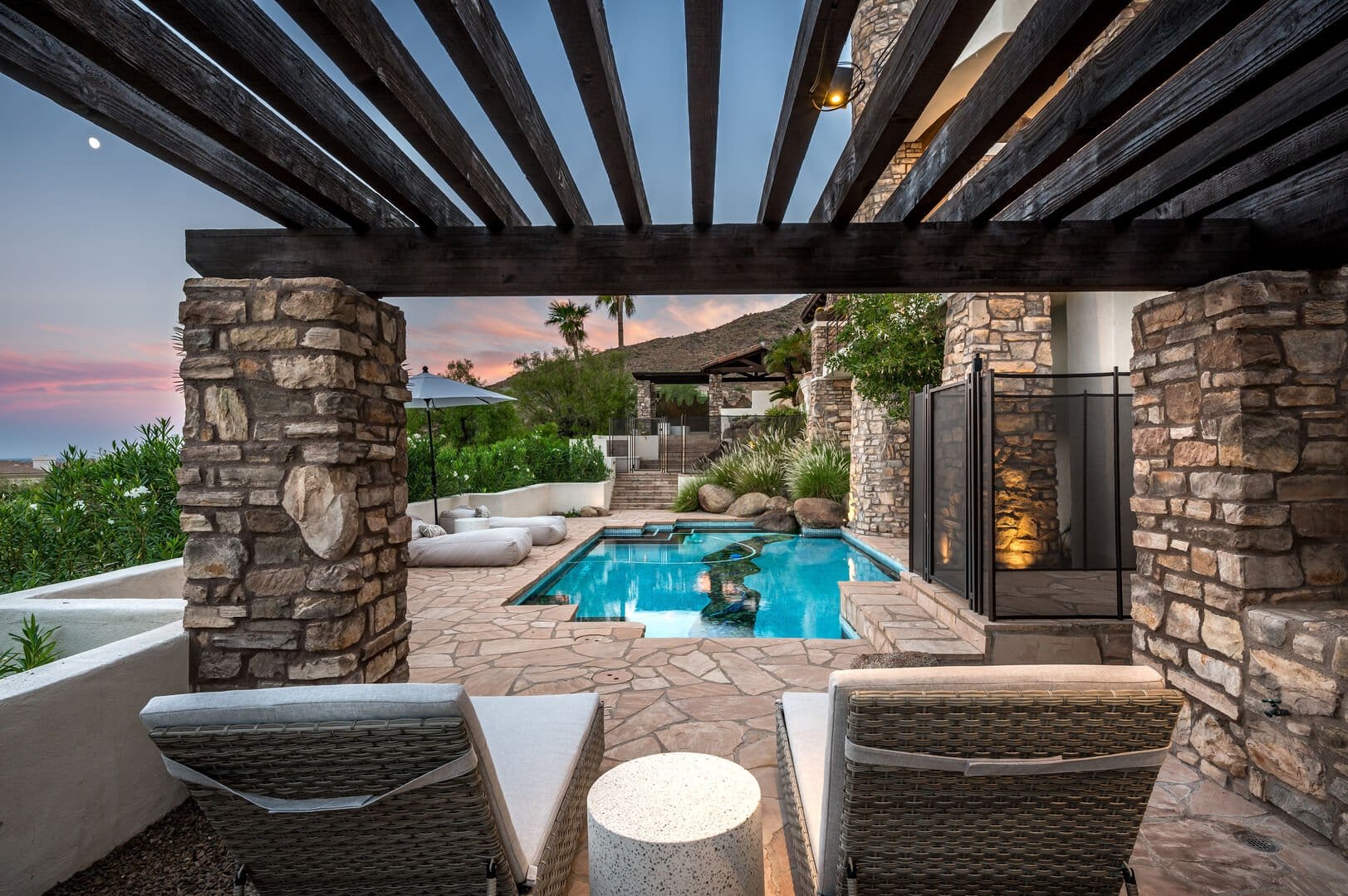 Luxurious poolside patio at sunset.