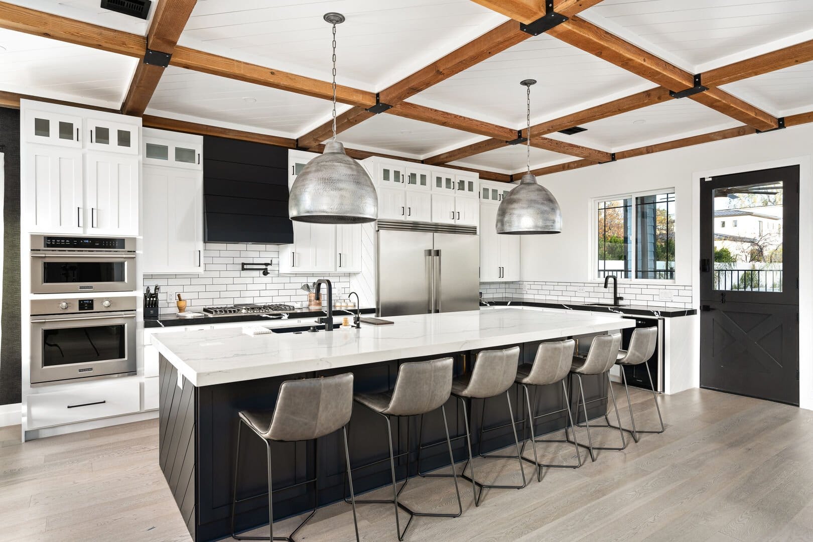 Modern kitchen with island and stools.