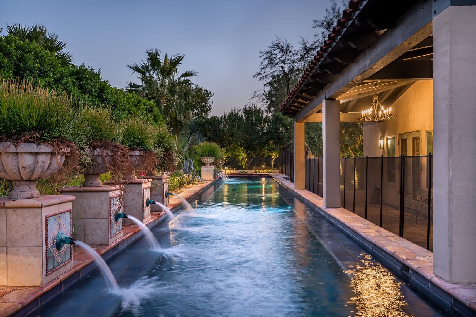 Luxurious backyard pool at dusk.