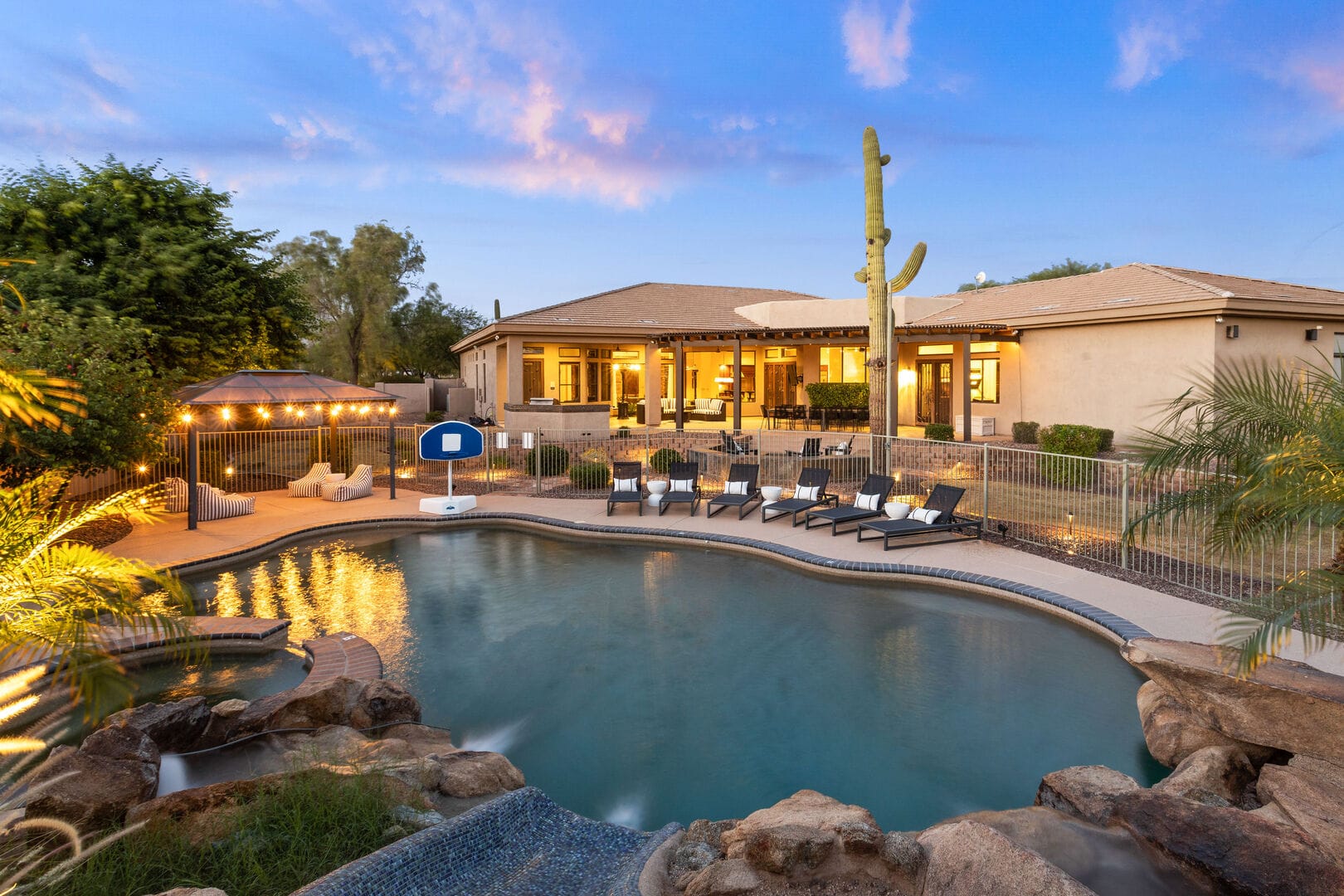 Backyard pool with lounge chairs.