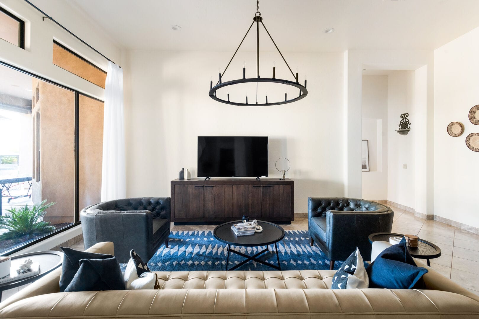 Modern living room with circular chandelier.