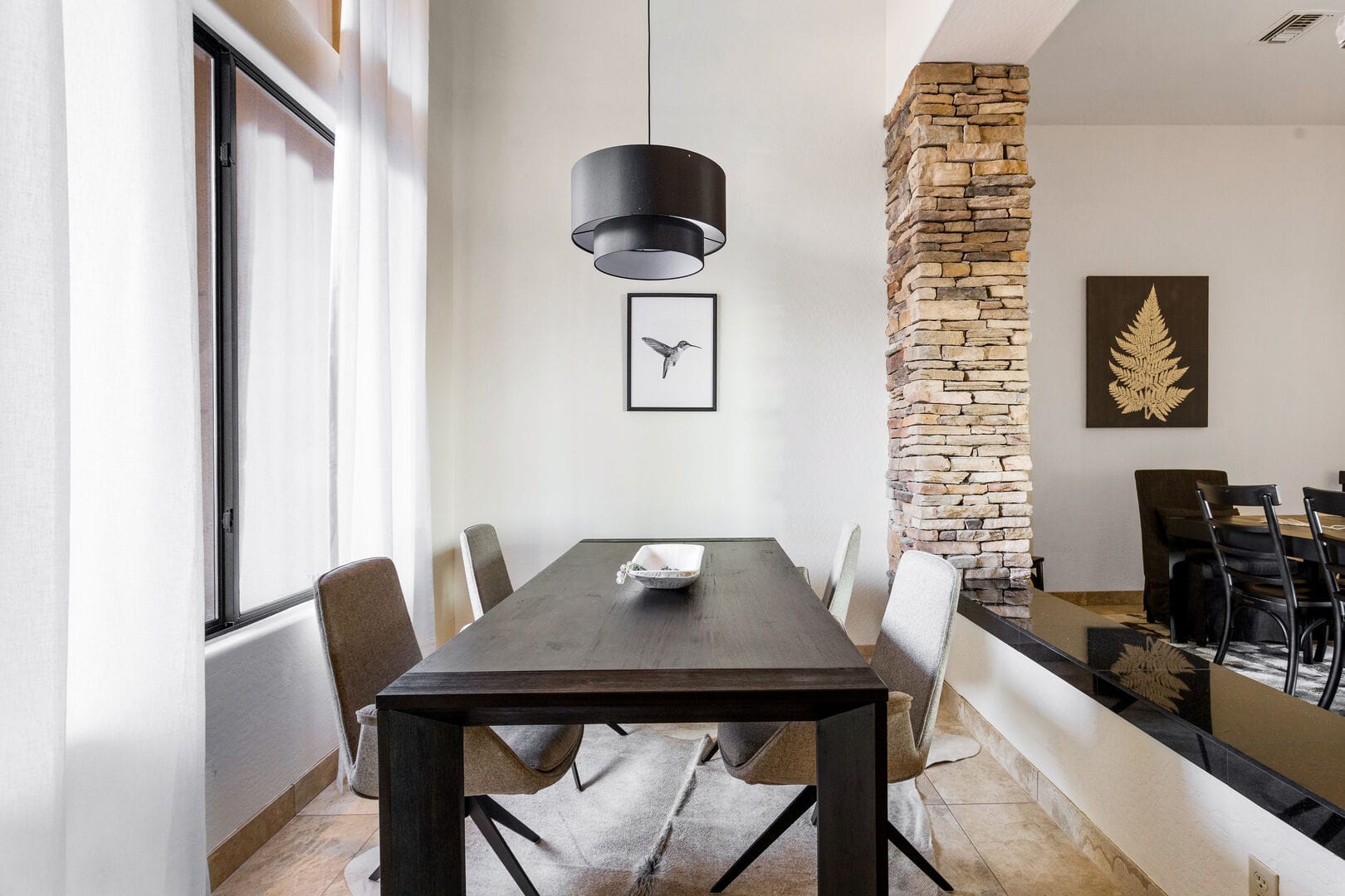 Modern dining room with stone pillar.