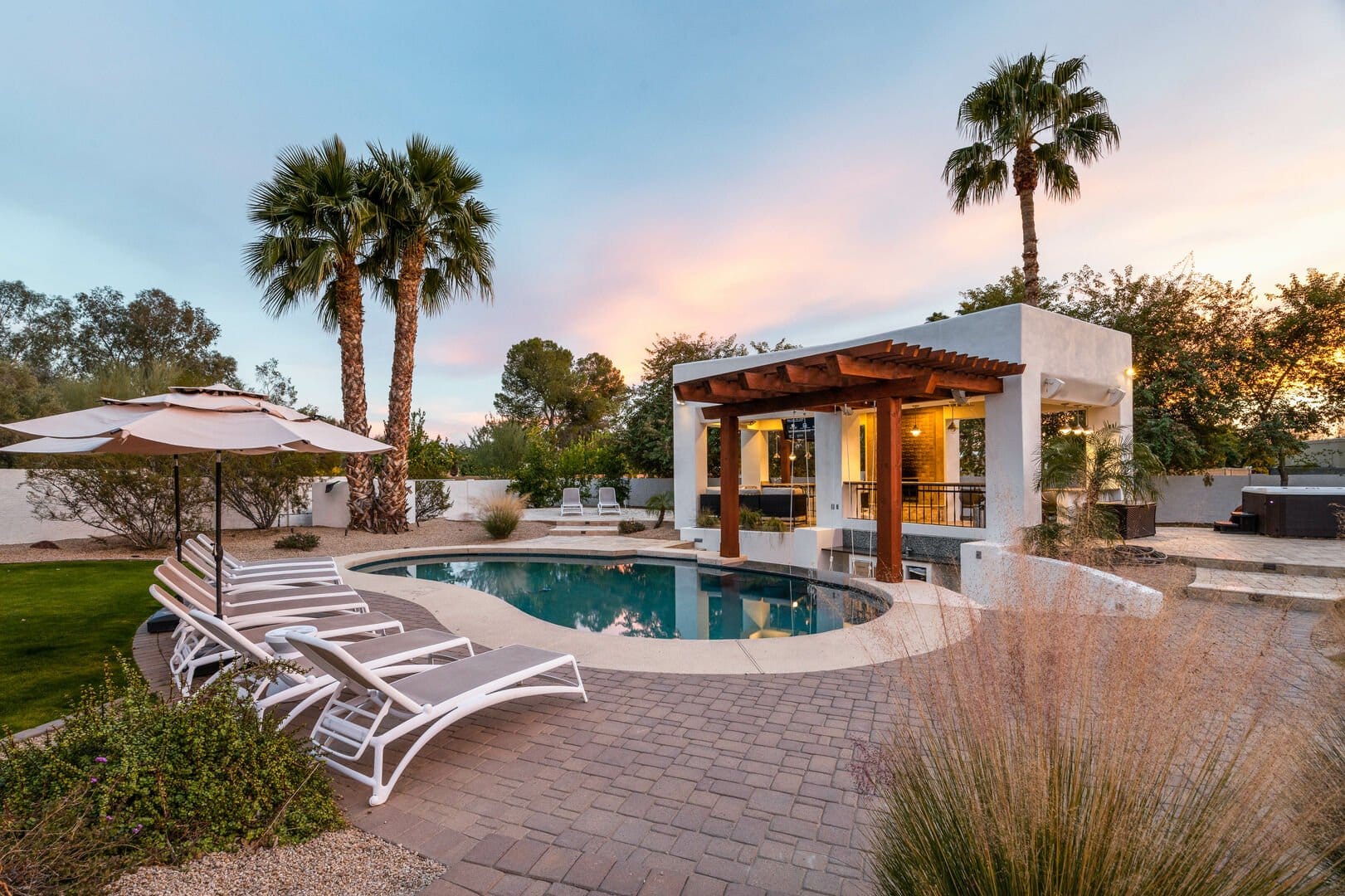 Backyard pool with lounge chairs.