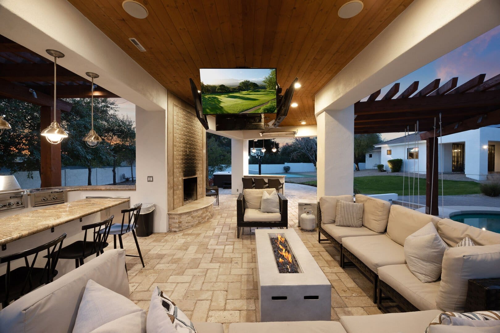 Outdoor patio with seating and fireplace.