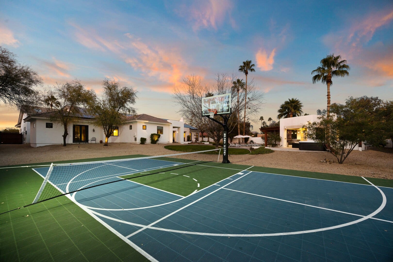 Backyard with multi-sport court.