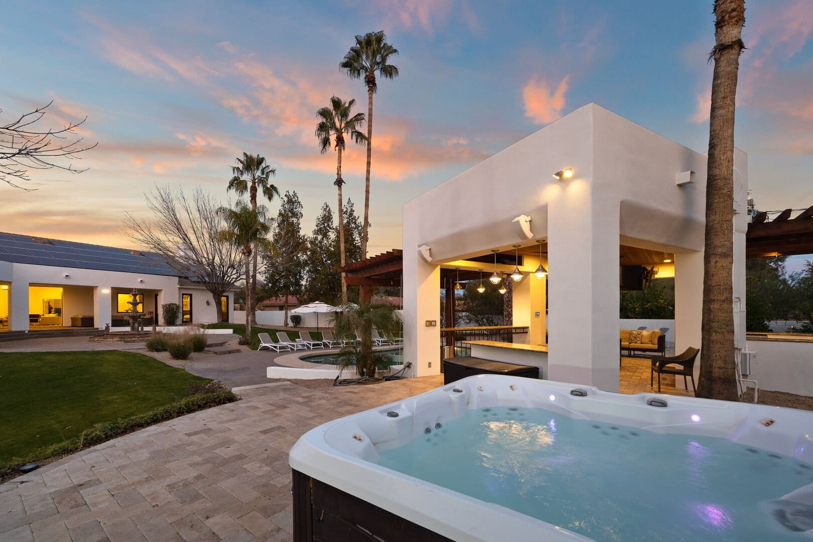 Modern backyard with pool and jacuzzi.