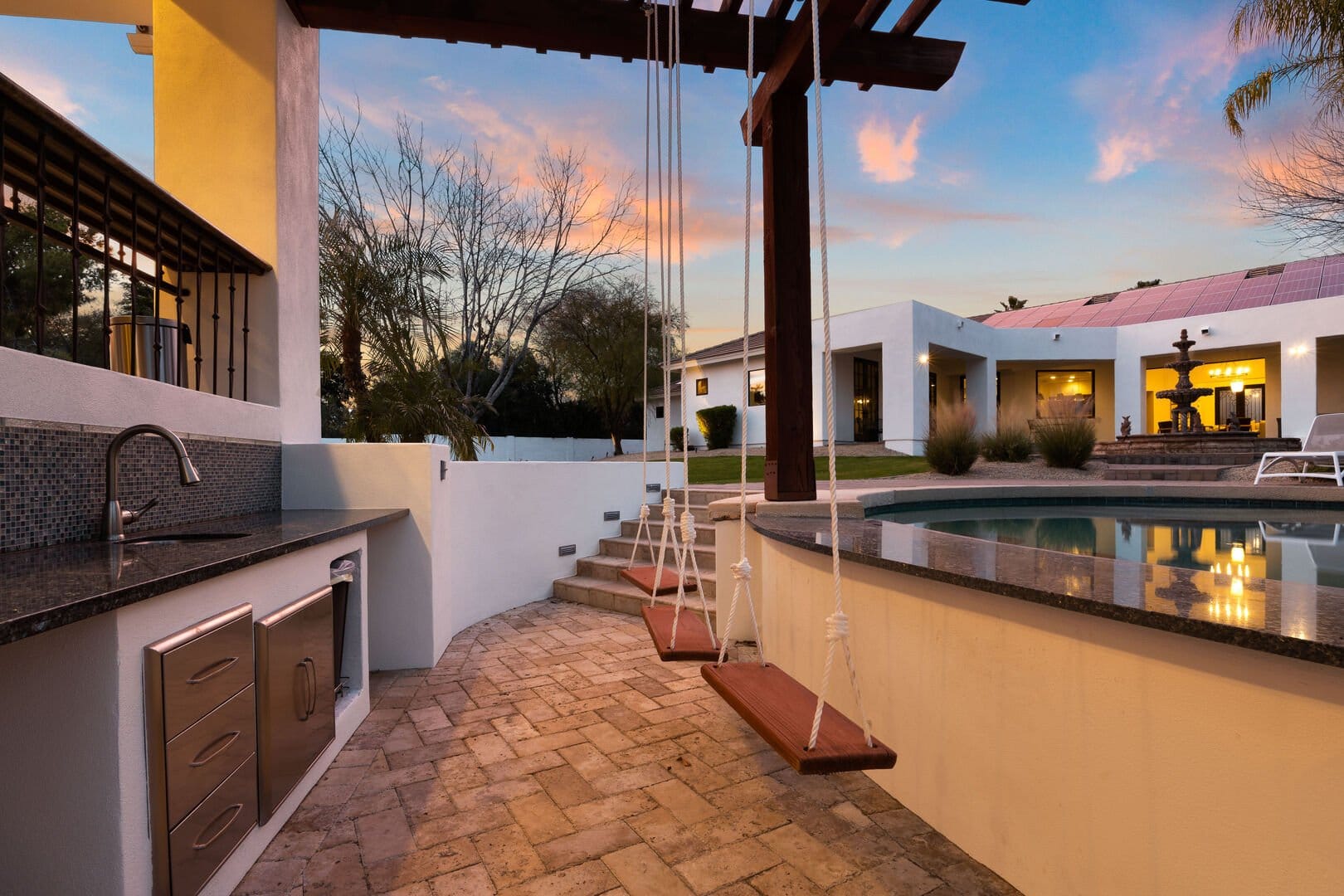 Outdoor kitchen and poolside swings