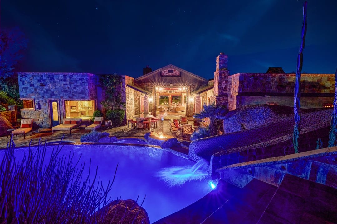 Nighttime view of lit swimming pool.