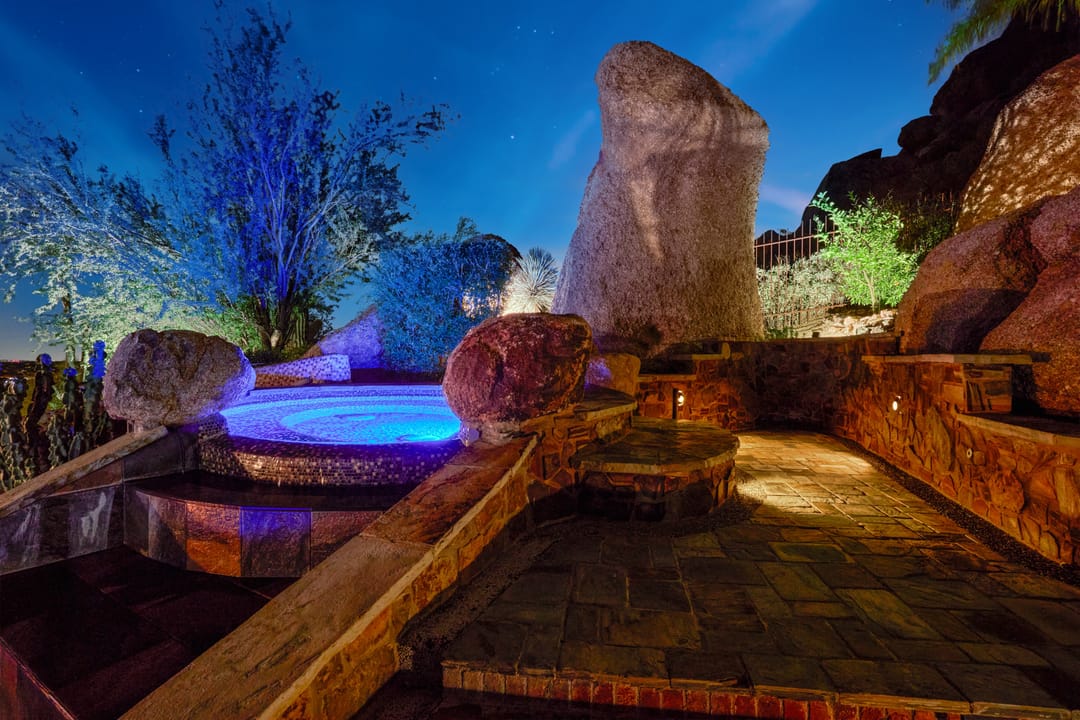 Rock garden with illuminated water feature.